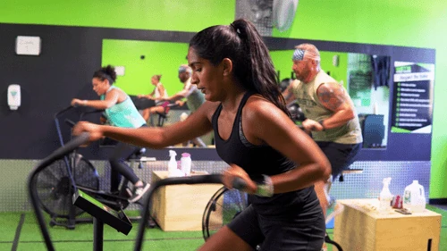 People using exercise equipment in an indoor training space