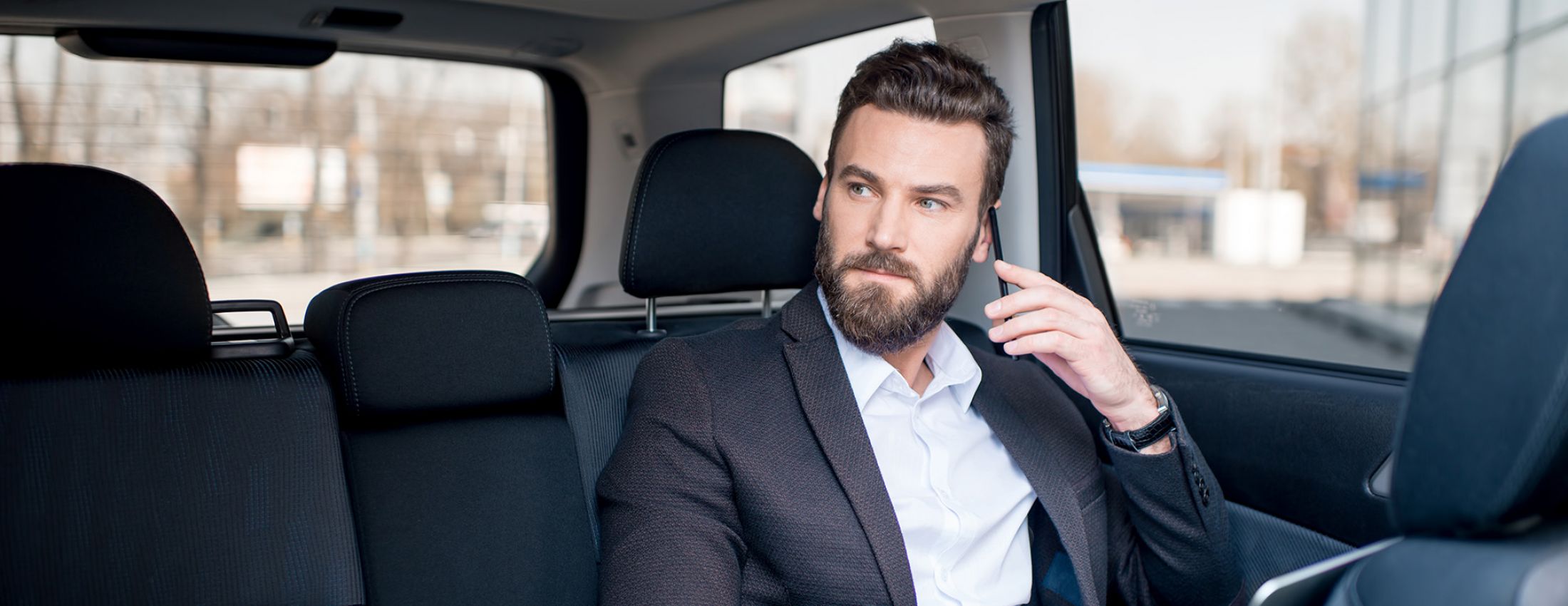 A passenger seated in the rear of a car