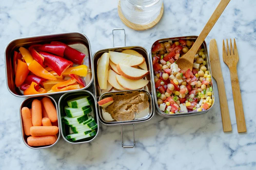 Several open food containers arranged on a table