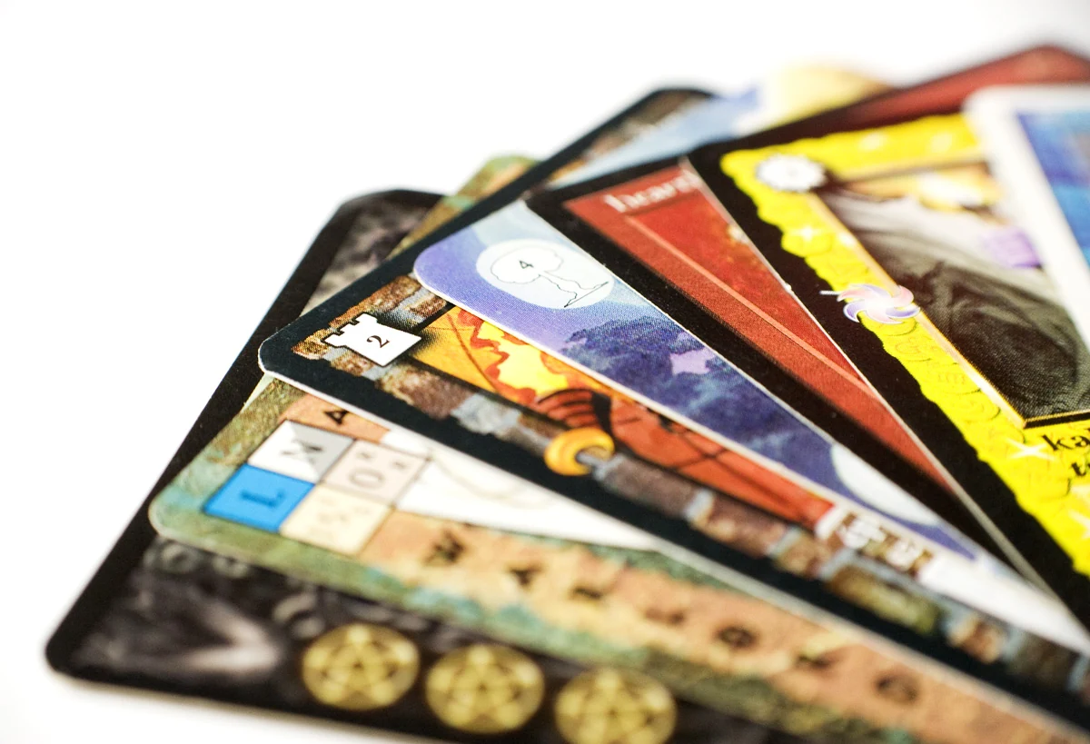 Several illustrated trading cards overlapping