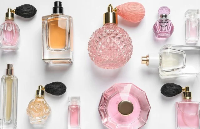 A group of perfume bottles on a light surface