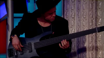 Michael Thurber playing an electric bass during a performance