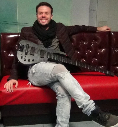 Michael Thurber seated with an electric bass